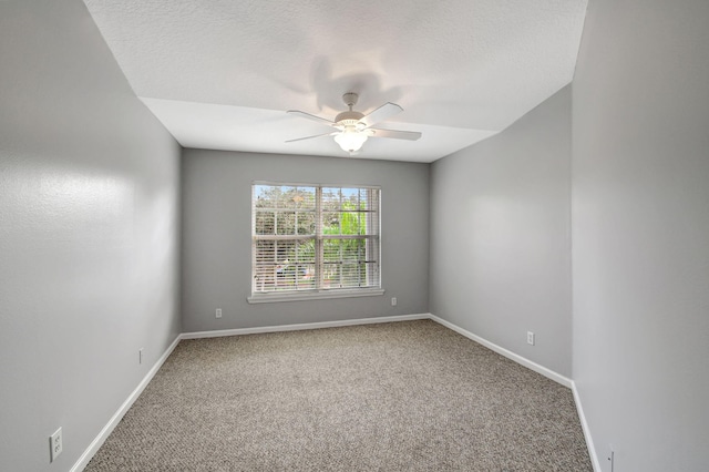 spare room featuring ceiling fan and carpet