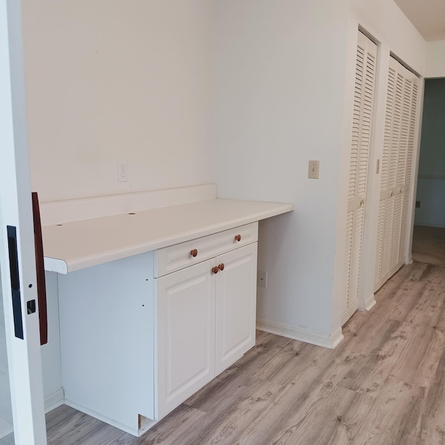 interior space featuring white cabinetry and light hardwood / wood-style floors