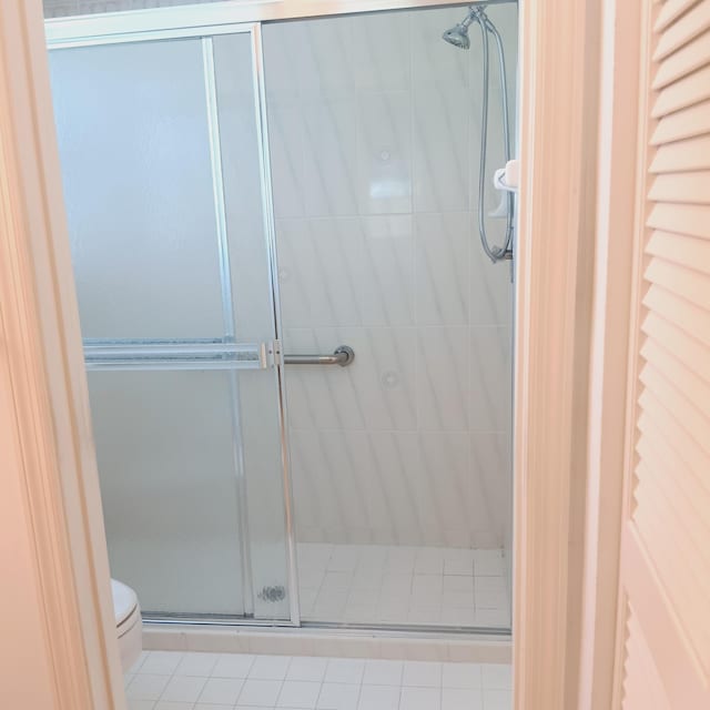 bathroom with walk in shower and toilet