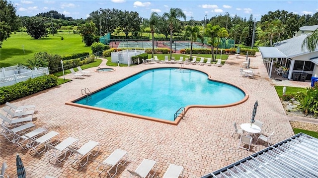 view of swimming pool featuring a community hot tub and a patio area