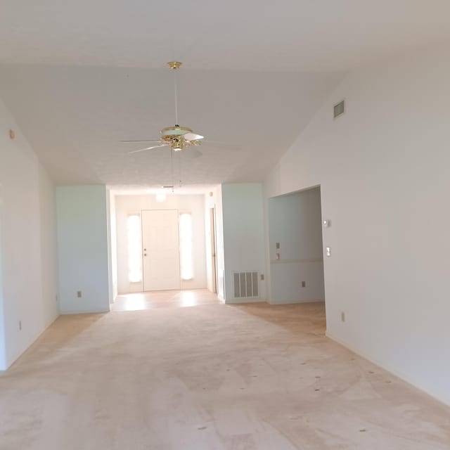 empty room featuring ceiling fan and high vaulted ceiling