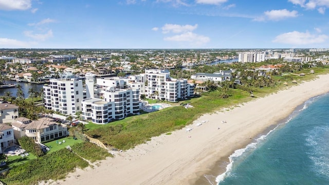 drone / aerial view featuring a water view and a beach view