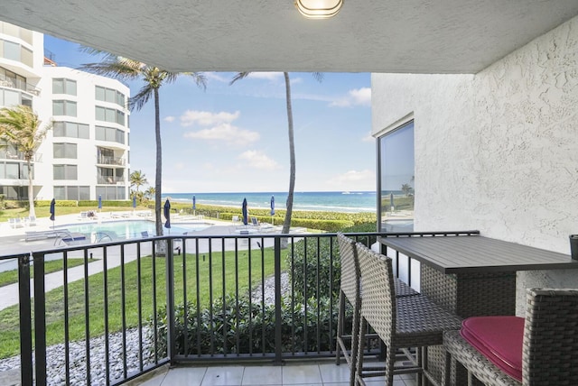 balcony with a view of the beach and a water view