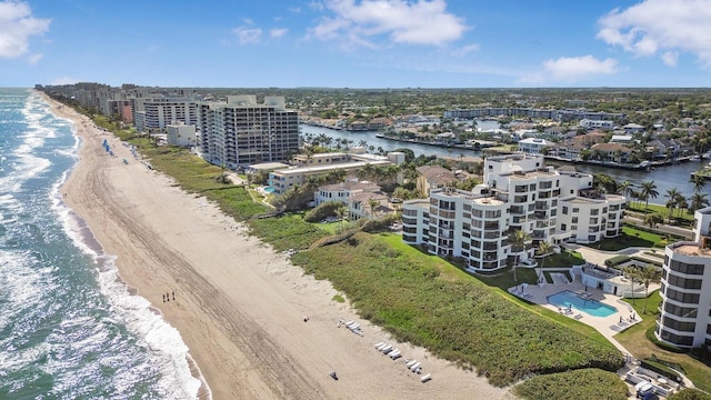 birds eye view of property with a view of the beach and a water view