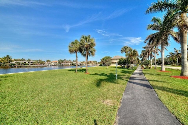 surrounding community featuring a lawn and a water view