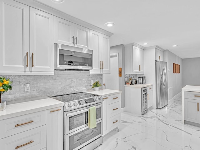 kitchen with wine cooler, white cabinets, decorative backsplash, and stainless steel appliances