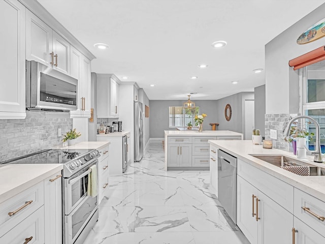 kitchen with sink, white cabinetry, stainless steel appliances, and tasteful backsplash