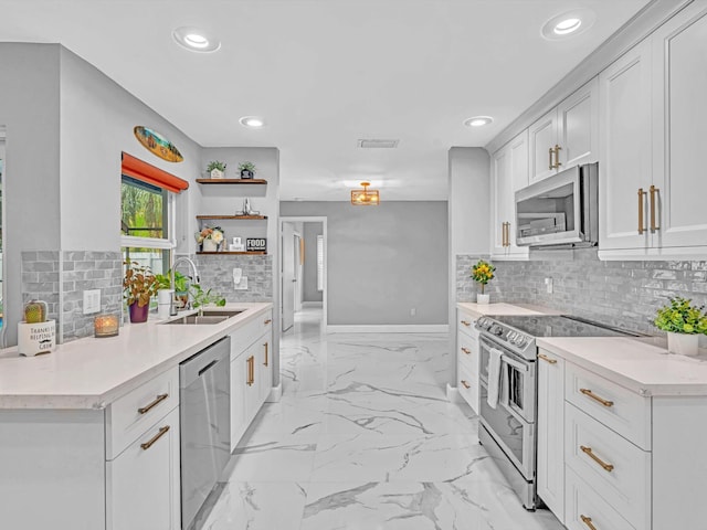 kitchen with stainless steel appliances, backsplash, white cabinetry, and sink