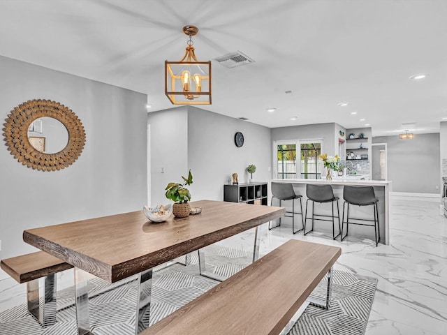 dining space with a chandelier