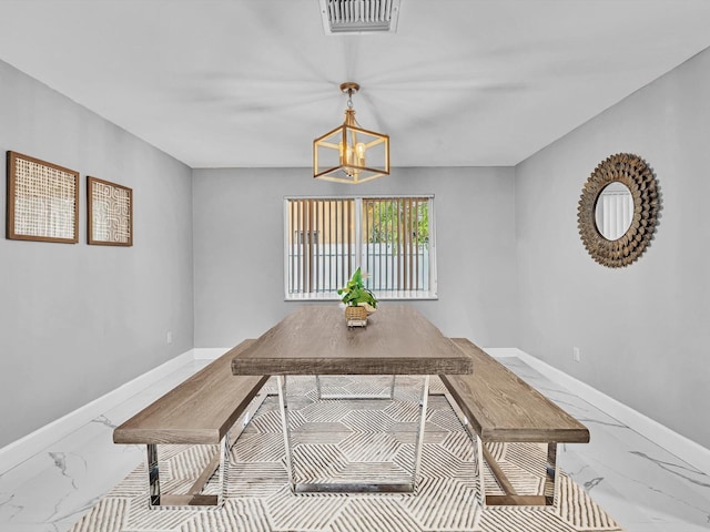 dining space featuring a notable chandelier