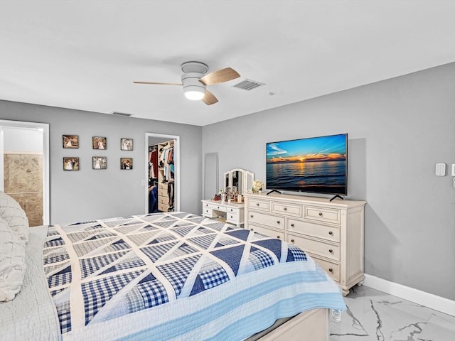 bedroom with ceiling fan, connected bathroom, a spacious closet, and a closet