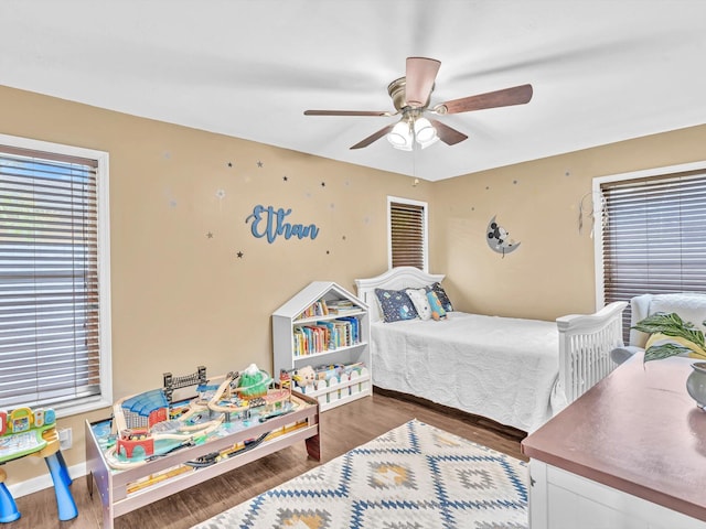 bedroom with ceiling fan and dark hardwood / wood-style floors