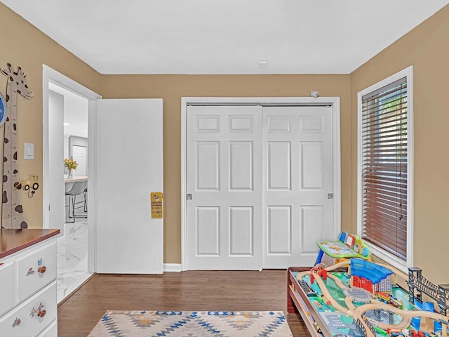 game room with dark hardwood / wood-style flooring