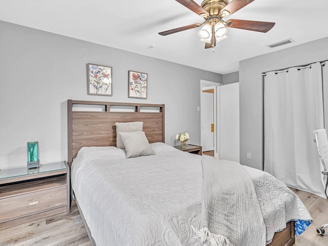 bedroom with ceiling fan and light hardwood / wood-style floors