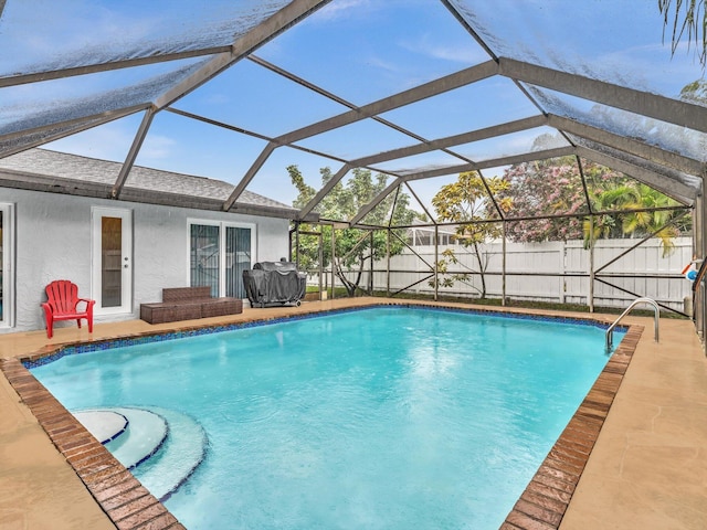 view of pool with glass enclosure