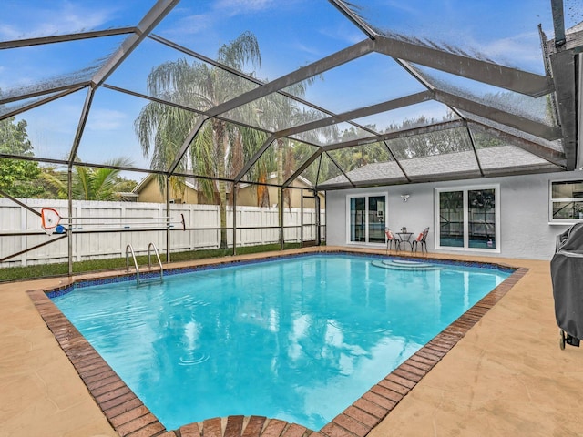 view of swimming pool with a lanai and a patio area