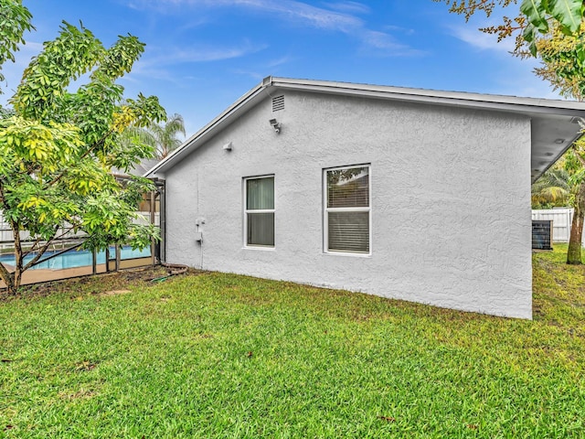 rear view of property with a lawn