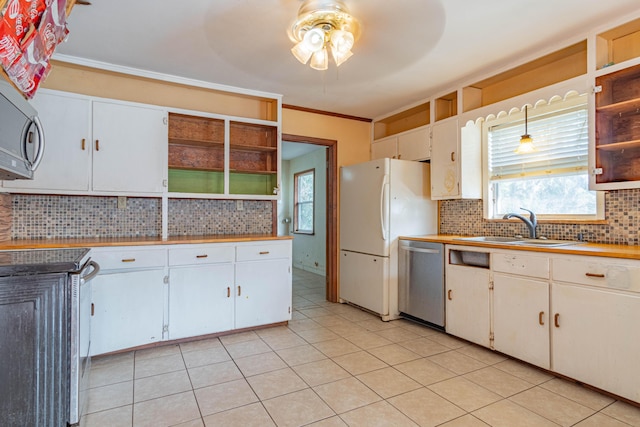 kitchen featuring sink, backsplash, white cabinetry, stainless steel appliances, and ornamental molding