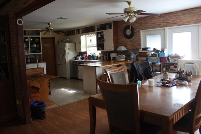 dining room featuring ceiling fan, a wealth of natural light, and light hardwood / wood-style floors