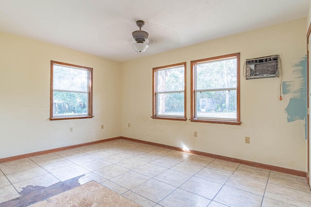 tiled spare room featuring a wall mounted air conditioner, a healthy amount of sunlight, and ceiling fan