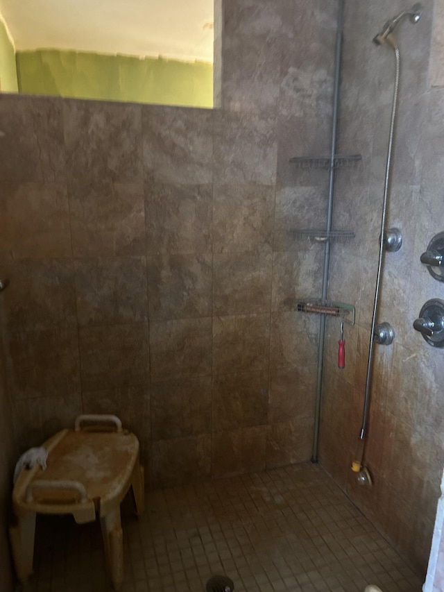 bathroom with tiled shower