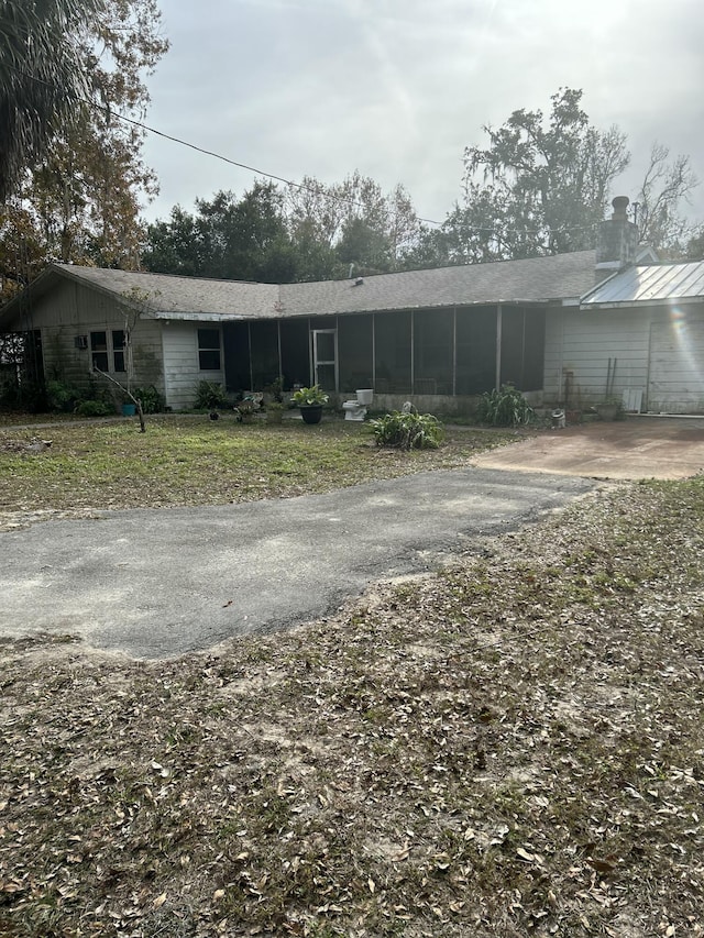 back of house featuring a sunroom