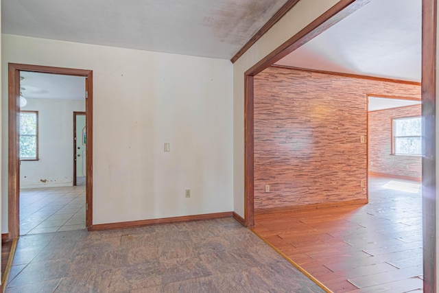 empty room with crown molding and wood-type flooring