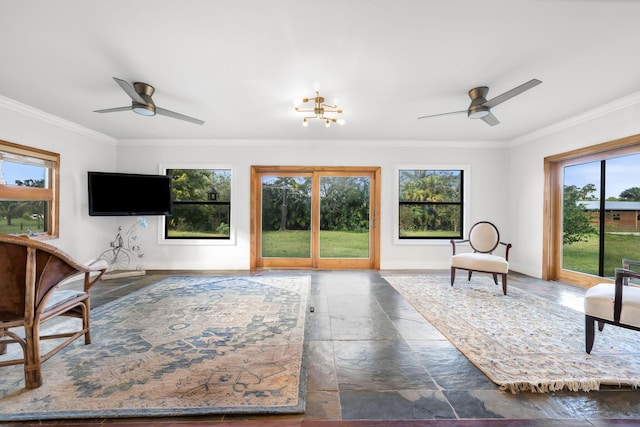 living room with ornamental molding and ceiling fan