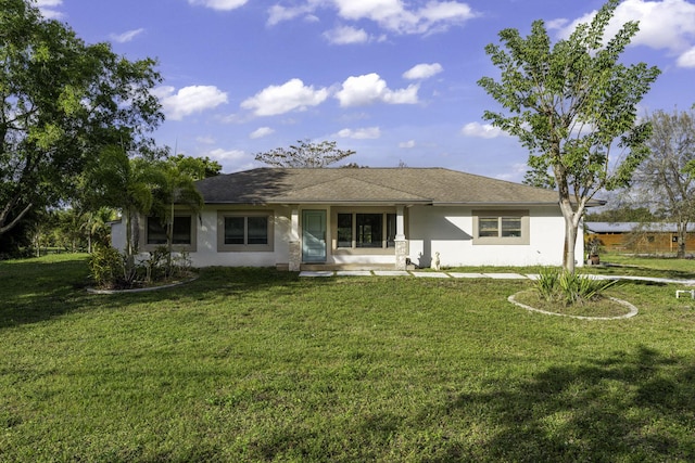 rear view of property featuring a yard