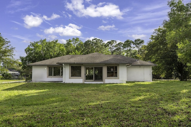 back of property featuring a lawn