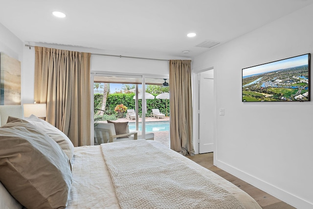 bedroom featuring wood-type flooring and access to outside