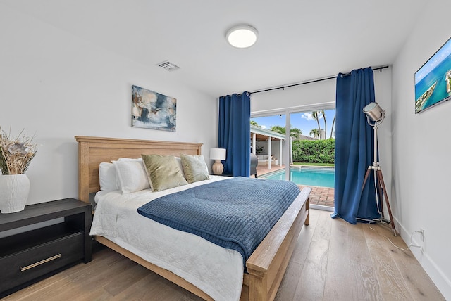 bedroom with light wood-type flooring and access to outside