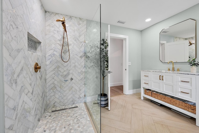 bathroom featuring vanity and a tile shower