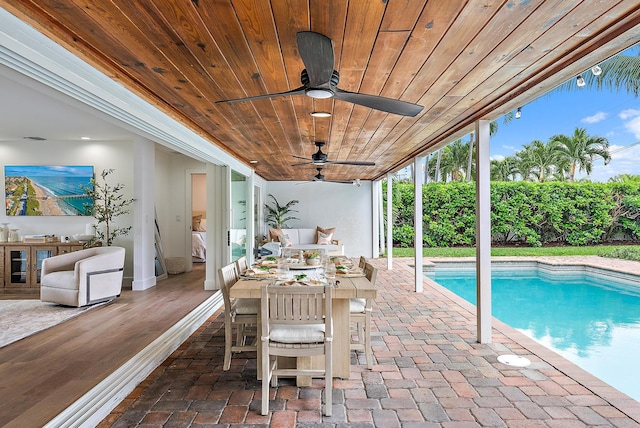 view of pool featuring ceiling fan and a patio