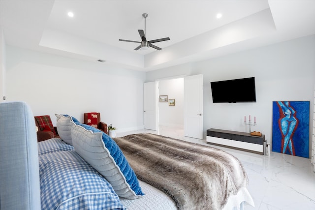 bedroom featuring ceiling fan and a tray ceiling