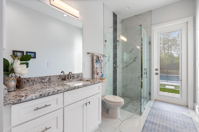 bathroom featuring vanity, toilet, and walk in shower