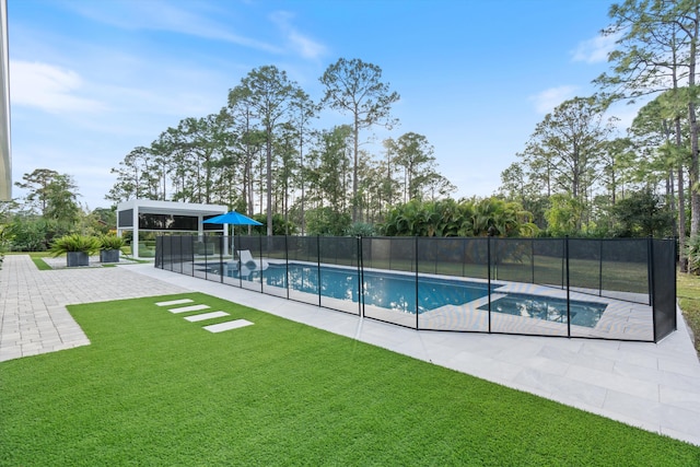 view of pool with a lawn and a patio