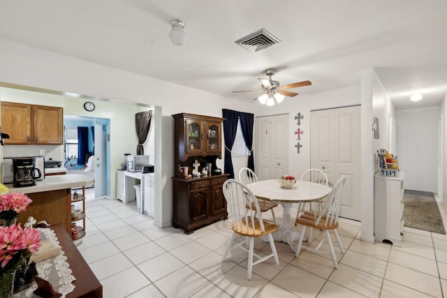 dining room featuring ceiling fan and light tile patterned floors