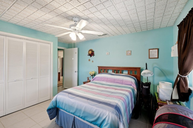 bedroom with ceiling fan, a closet, and light tile patterned flooring