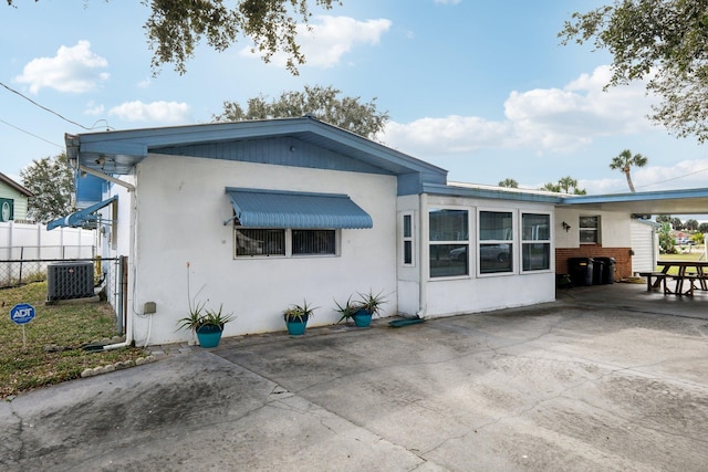 rear view of property with cooling unit