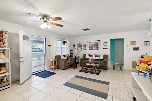 tiled living room featuring ceiling fan