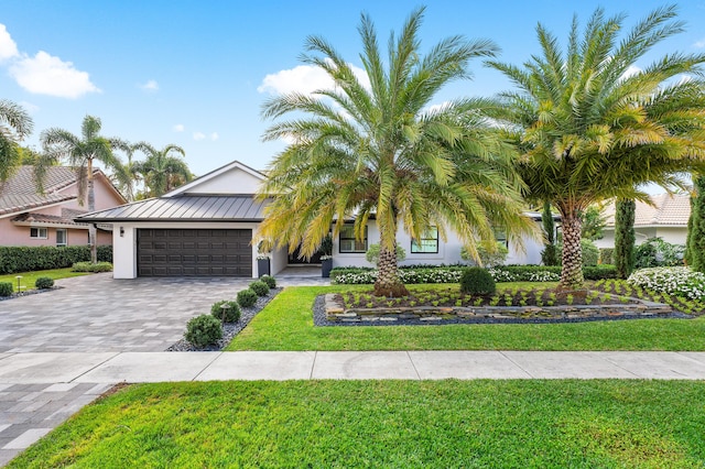 view of front of house with a garage and a front yard