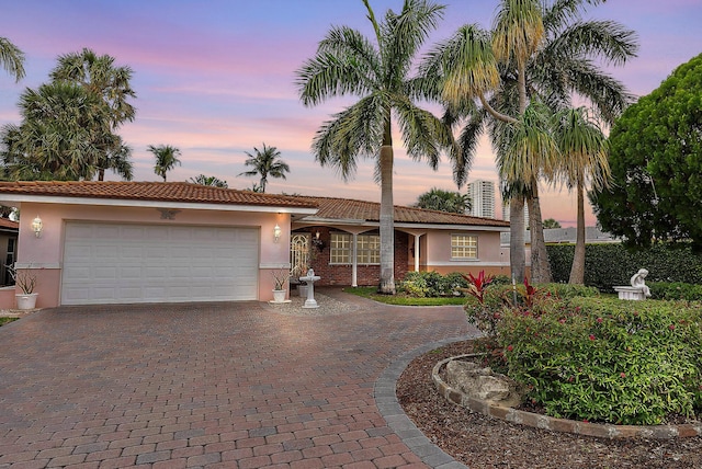 view of front of property featuring a garage, driveway, and stucco siding