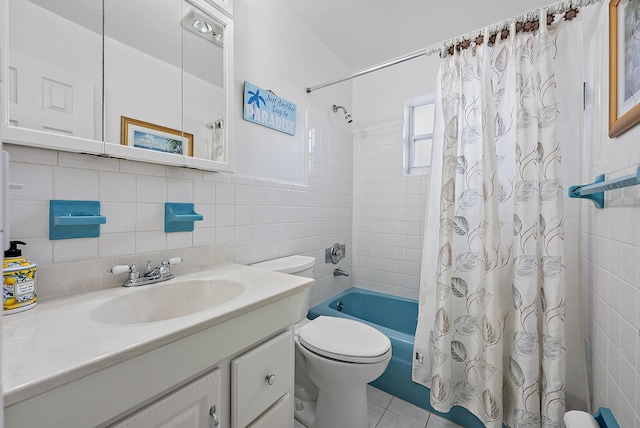 bathroom with tile patterned floors, shower / bath combo, toilet, tile walls, and vanity