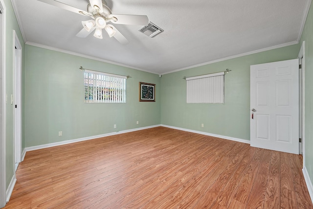interior space featuring baseboards, crown molding, visible vents, and light wood-type flooring