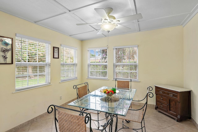 tiled dining area with ceiling fan and coffered ceiling