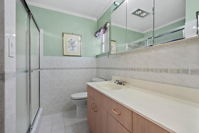 bathroom with tile patterned floors, a stall shower, tile walls, crown molding, and vanity