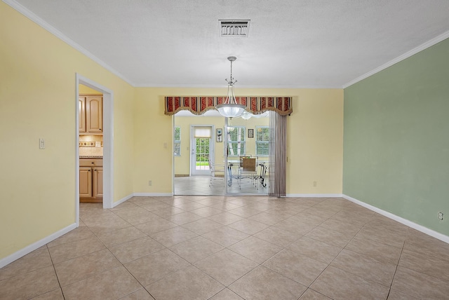 unfurnished room featuring baseboards, ornamental molding, visible vents, and light tile patterned floors