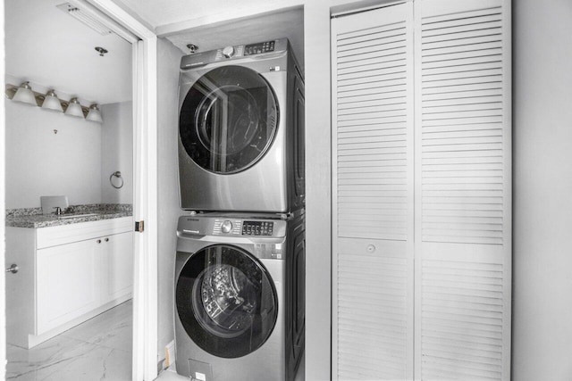 clothes washing area with stacked washer and dryer