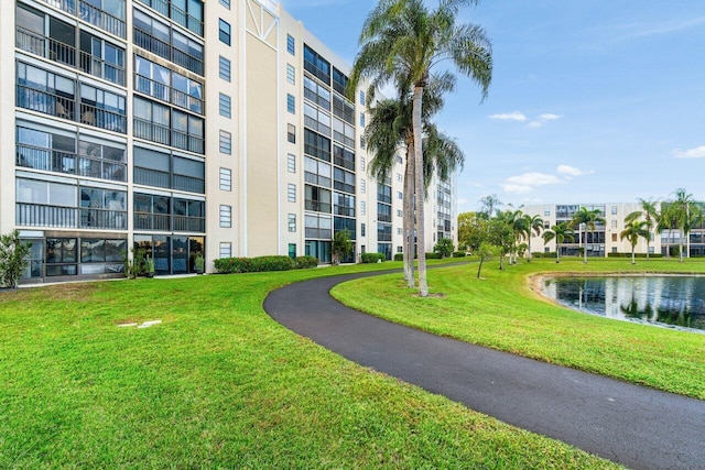 view of home's community featuring a water view and a yard